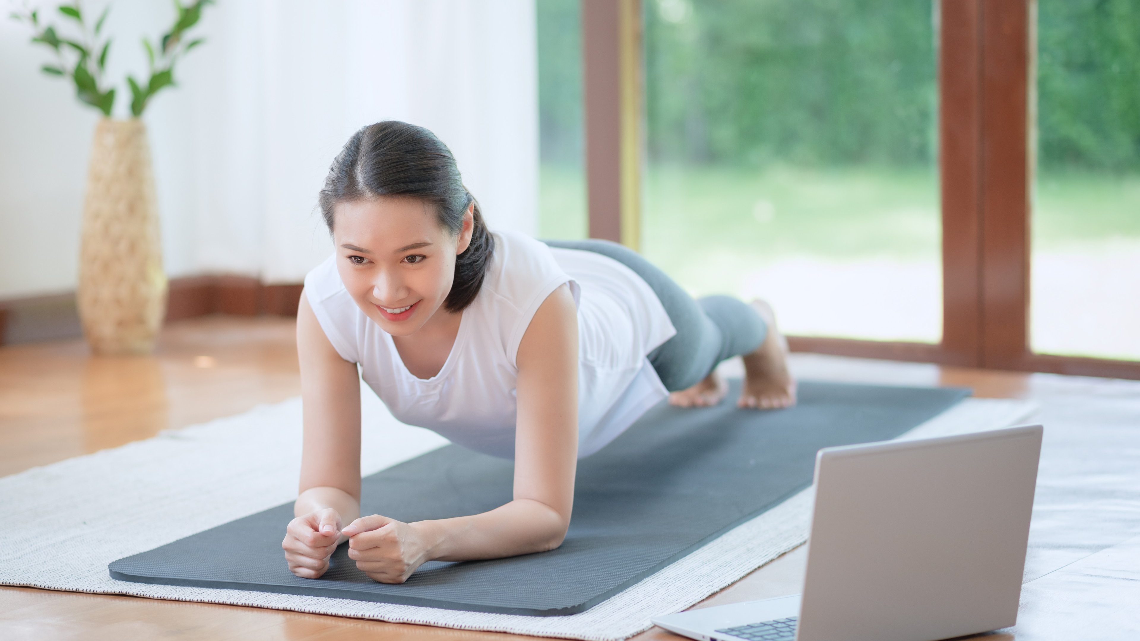 Beautiful asian woman staying fit by exercising at home for healthy trend lifestyle